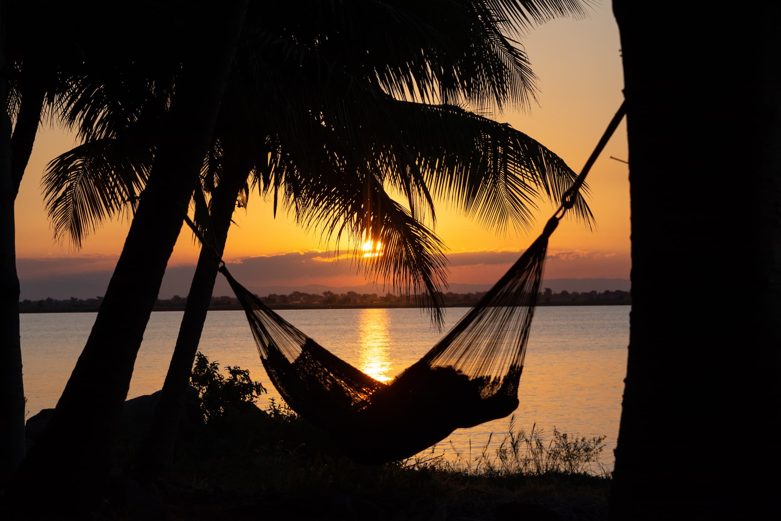 alt="hammock at sunset in lake malawi-explore malawi highlights-travel with la french"