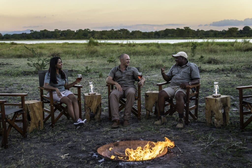 alt="sundowner around the fireplace at kuthengo camp in liwonde national park-explore malawi highlights-travel with la french"